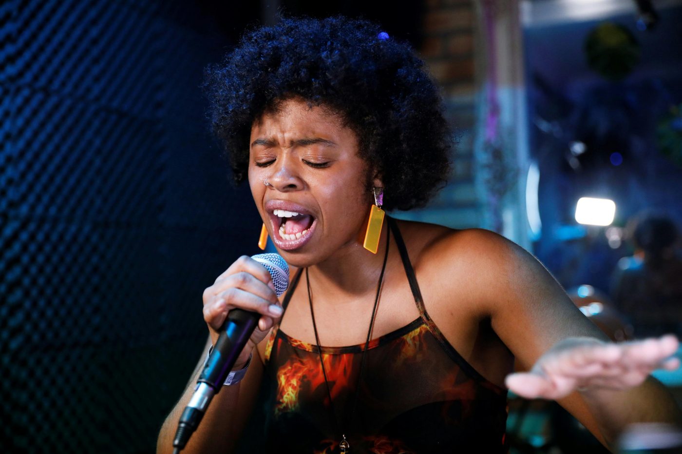 A soul singer performing passionately into a microphone